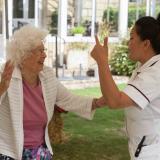 Nurse and resident dancing